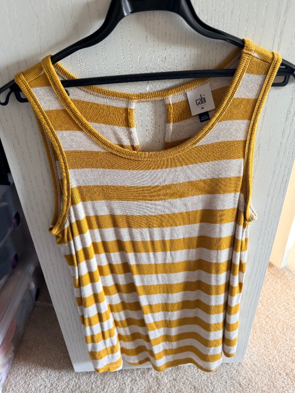 This is a Cabi Liner Tank in a mustard gold and cream stripe pattern. size M